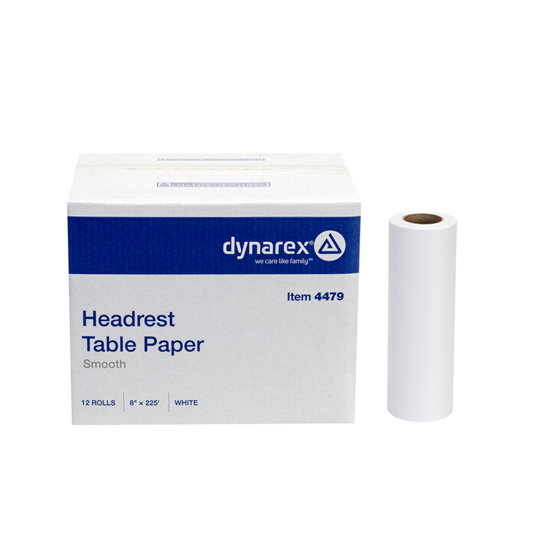 A box of Dynarex Exam Table Paper, containing 12 rolls (each 8" x 225'), sits beside a single white roll, offering a protective barrier.